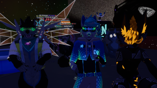 VRChat picture of Club FYNN, with me in the center surrounded by a couple of friends and many others dancing in the background.